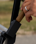 Golfer placing a cigar in a magnetic BogeyforStogies golf-cart holder